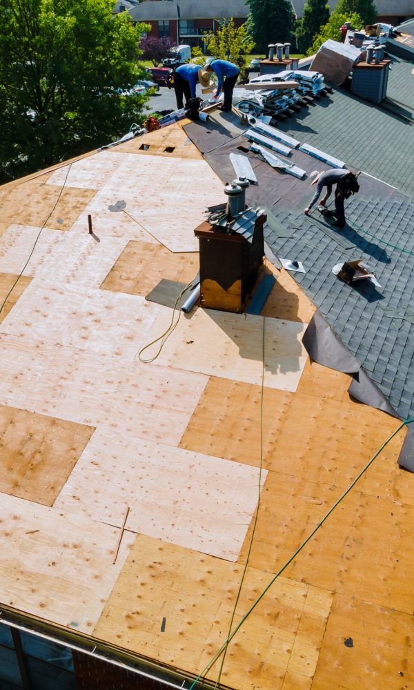 Roof repairs old roof replacement with new shingles of an apartment building